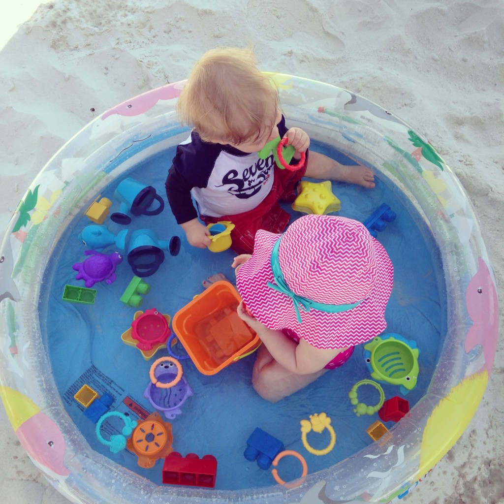 This is Charlee and Hayes in their kiddie pool at the beach.